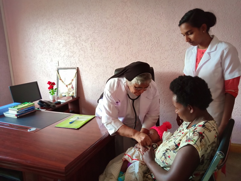 Sister Mary Easey, (Left) administering medicine at St Angela Merici Hospital in Uganda