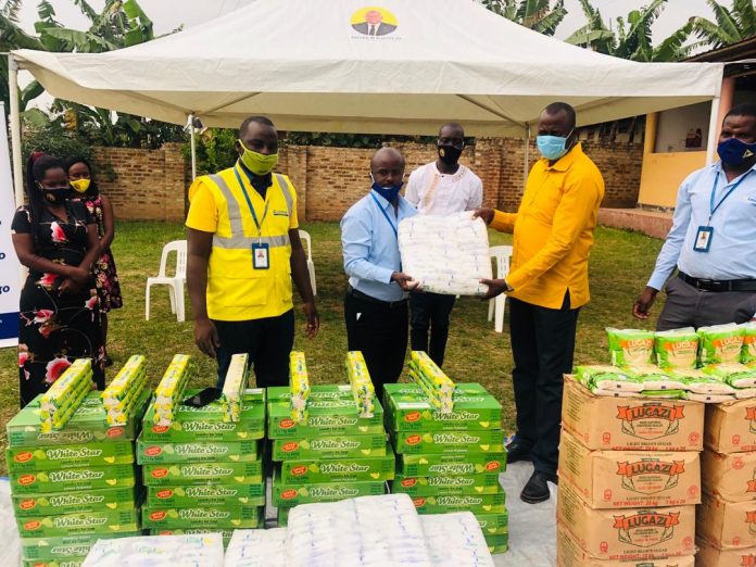 Roger Mugisha Corporate Communications Manager Letshego hands over items worth UGX4M to Hon Haruna Kyeyune Kasolo MP of Kyotera as a COVID relief contribution.