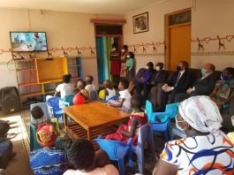 Team from British High Commission and parents of Cancer patients watch video clip on Bless A Child Foundation.